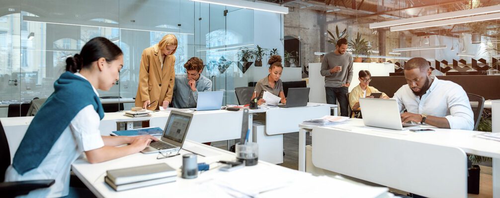 Hot desking is commonly used term to describe a concept where a limited number of available workspaces is shared amongst a workforce that does not need a permanently assigned desk.