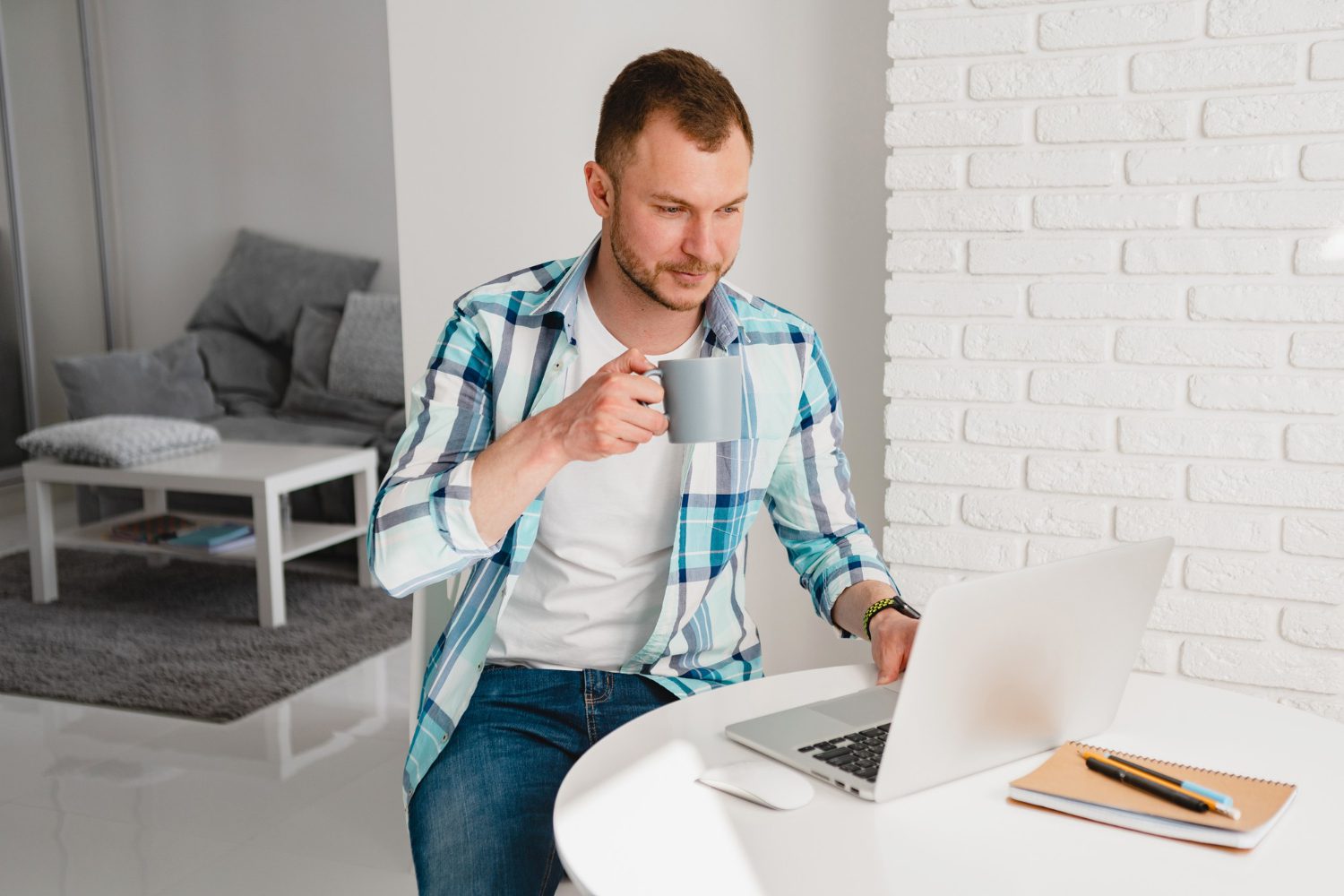 handsome-smiling-man-shirt-sitting-kitchen-home-table-working-online-laptop-from-home